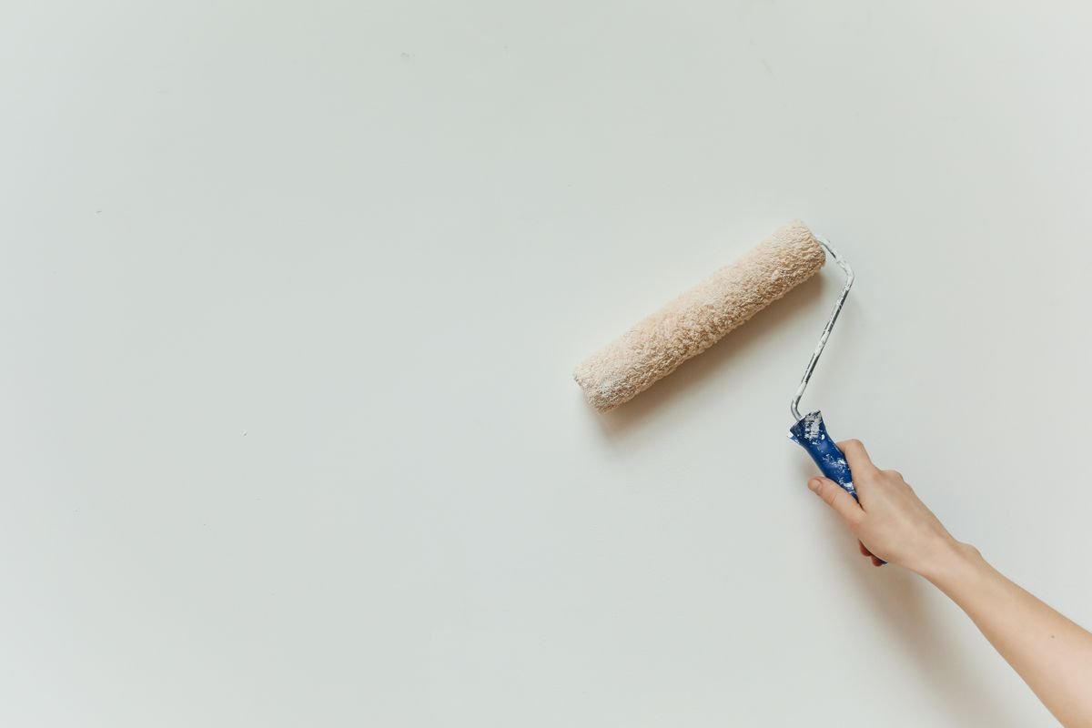 Wall being painted with a roller during a decorating job