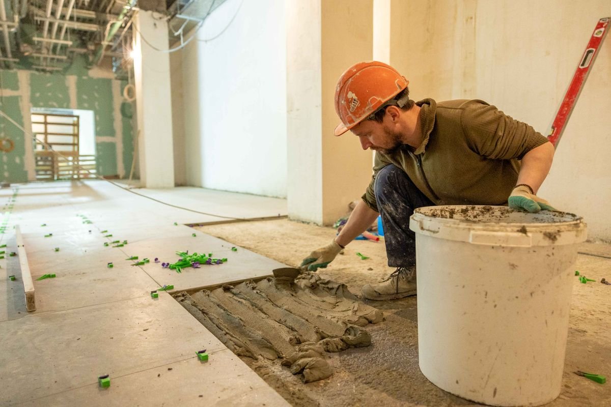 Floor tiles being laid during an installation
